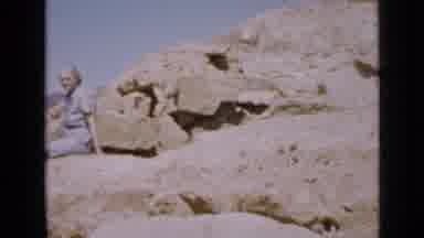 Utah USA (1939): Woman Wearing Blue Dress Sits On Rock On A Sunny Day