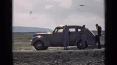 Utah USA (1939): 1940s Era Automobiles Parked On Side Of A Road In The Middle Of