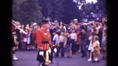 Ontario Canada (1940): Marching Band Wearing Kilts Walks Through Busy Town Fair