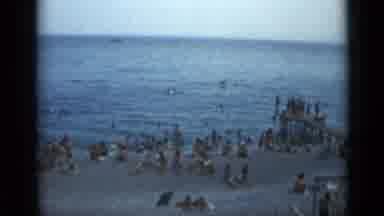 Cannes France (1962): People Sitting On Sand And Standing In Water At Beach On A