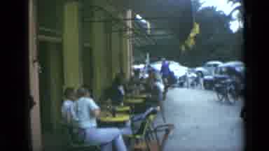 Cannes France (1962): Woman Walking Out Of Cafe/Restaurant While Others Are