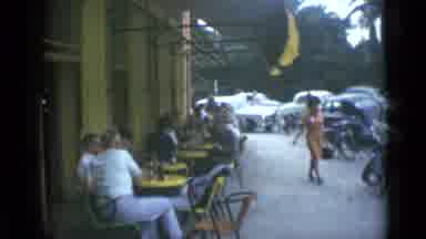 Cannes France (1962): People Sit Outside At The Cafe As People Riding Horses Go By