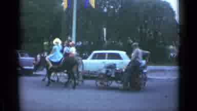 Cannes France (1962): People Riding Down A City Street On A Buggy Pulled By Mules