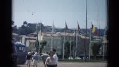 Cannes France (1962): View Of Flags Flying In Front Of Tan Buildings On A Sunny