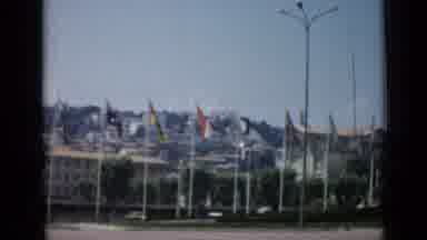 Cannes France (1962): Flags Cars People Building Light Office Grass Bushes Window