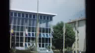 Cannes France (1962): A View Of Tall White Buildings With Windows And Flags