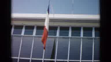 Cannes France (1962): View Of Flags In Front Of Modern Building With Black And