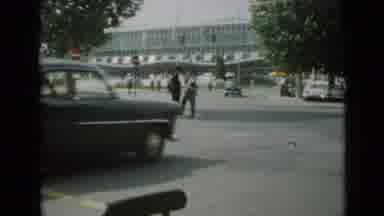 Cannes France (1962): Busy Street Scene That Has Some Cars Driving Through An