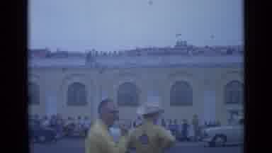 Cannes France (1962): Many People In Front Of And On Top Of A Long Yellow Building
