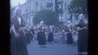 Cannes France (1962): Nicely Dressed Woman And Men March Proudly Through The