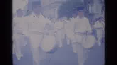 Cannes France (1962): Marching Band Wearing White Uniforms Walking Down City