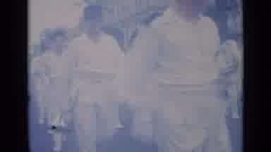 Cannes France (1962): Marching Band Dressed In White Travels Through A City Street