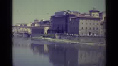 Florence Italy-1962: View Of Tan Buildings And River On A Sunny Day