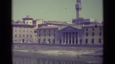 Florence Italy-1962: Vehicles Moving On Bridge Over River In City