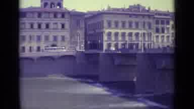 Florence Italy-1962: View Of Rustic Buildings With Lots Of Windows Overlooking A Bridge