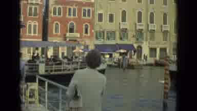 Florence Italy (1962): Woman Watches Multiple Passenger Boats Pass Through A