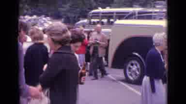 Germany (1962): Many People Walking In A Parking Lot While Camera Focuses On One