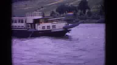 Germany (1962): A Boat Sails On The Water With A Small Town At The Base Of A