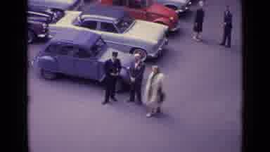 Germany (1962): Two Men Dressed In Suits Talking Next To A Parked Vehicle