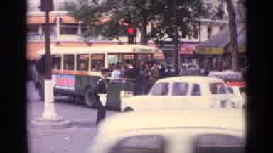 Germany (1962): Car Speed Through Traffic In The City As A Man Directs And Guides
