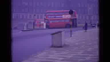 London England (1962): Two Double Decker Buses And Other Vehicles Drive Around A