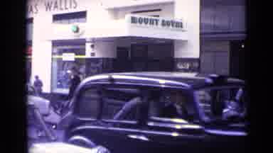 London England (1962): Video Of A City Area With Shops And Old Cars On A Street