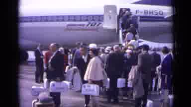 London England (1962): Several People Gathered Together Standing Outside Of An