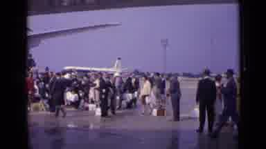 London England (1962): Several People Line Up To Board The Plane With Their Carry