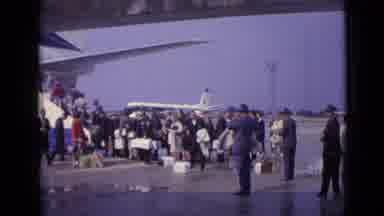 London England (1962): Many People In Line Waiting Outside To Board An Airplane