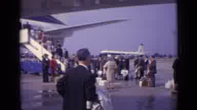 London England (1962): Large Group Of People Standing On Tarmac In Line To To Be