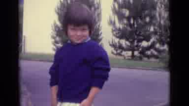 Lucerne Switzerland (1962): A Little Boy Dressed In A Blue Sweater Smirking At The