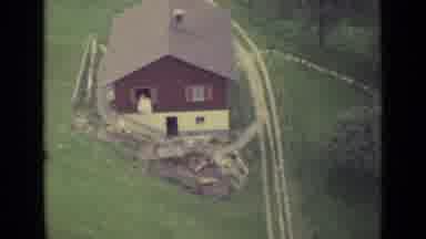 Lucerne Switzerland (1962): Air Shot Of A Red Country House And A Cliff With Pine