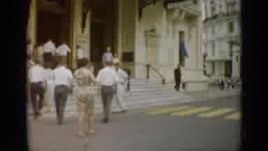 Monaco City (1962): People Go Up The Steps And Enter The Building As A Man Waves