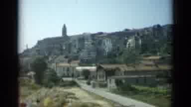 Monaco City (1962): View Of Many Buildings In The Background And A Grove Of Trees