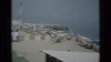 Monaco City (1962): Car Cam Passes Alongside A Sandy Beach Where Many People Relax