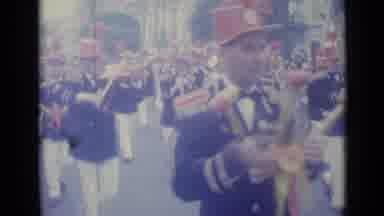 Nice France (1962): Band Wearing Black Jackets Marches In Parade On A Cloudy Day