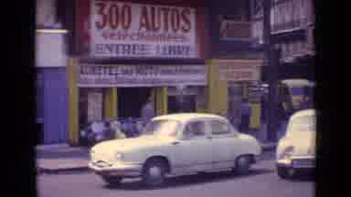 Paris France (1962): Driving Through Intersection Past People Walking On The