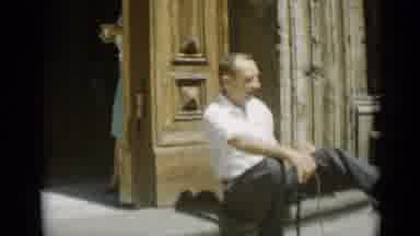 Rome Italy (1962): Woman In Green Backs Behind Doorway As Sitting Man Stretches