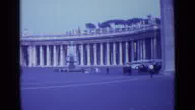 Rome Italy (1962): Man With Black Hat Waves Hand Toward Camera With Columns In