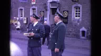 Switzerland (1962): Two Men In Uniform Stand In The Street In Front Of A Building