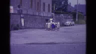 Switzerland (1962): Girls Wearing Grey Coats Follow Nun Towards Grey Car On A