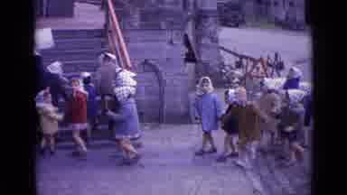 SWITZERLAND-1962: School Girls Walking In A Line With Bandanas On Their Heads
