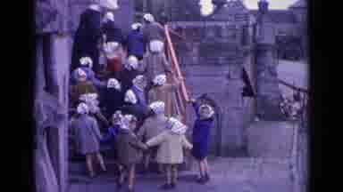 Switzerland (1962): Group Of Children Follow A Women Dressed As A Nun Up A Set Of