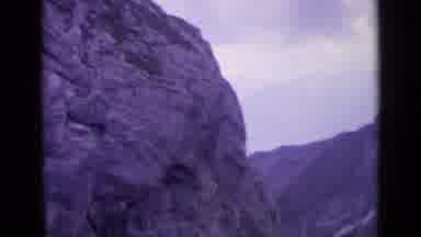Switzerland (1962): View Of Large Grey Rock Structure On A Cloudy Day