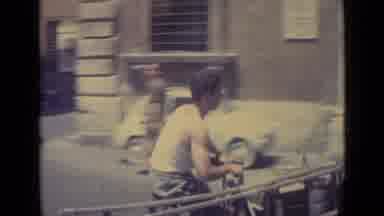Vatican City (1962): A Man On A Motor Scooter Passes A Vehicle On A Busy Street