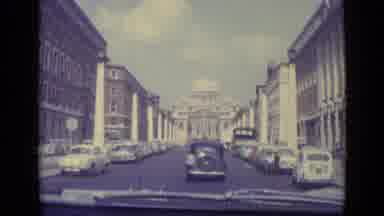 Vatican City (1962): Cars And Carriage On A Large City Street Headed Towards A