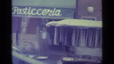 Vatican City (1962): Point Of View Shot From A Vehicle Of A Busy Store Front