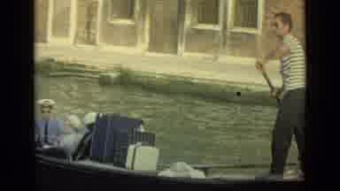 Venice Italy (1962): A Canal Boat Driver Carries People And Luggage Through The