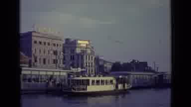 Venice Italy (1962): A River Boat Docks Outside A Campari Factory In Italy As