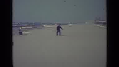 Venice Italy (1962): Person Walking Across A Dandy Beach With Net In Hand